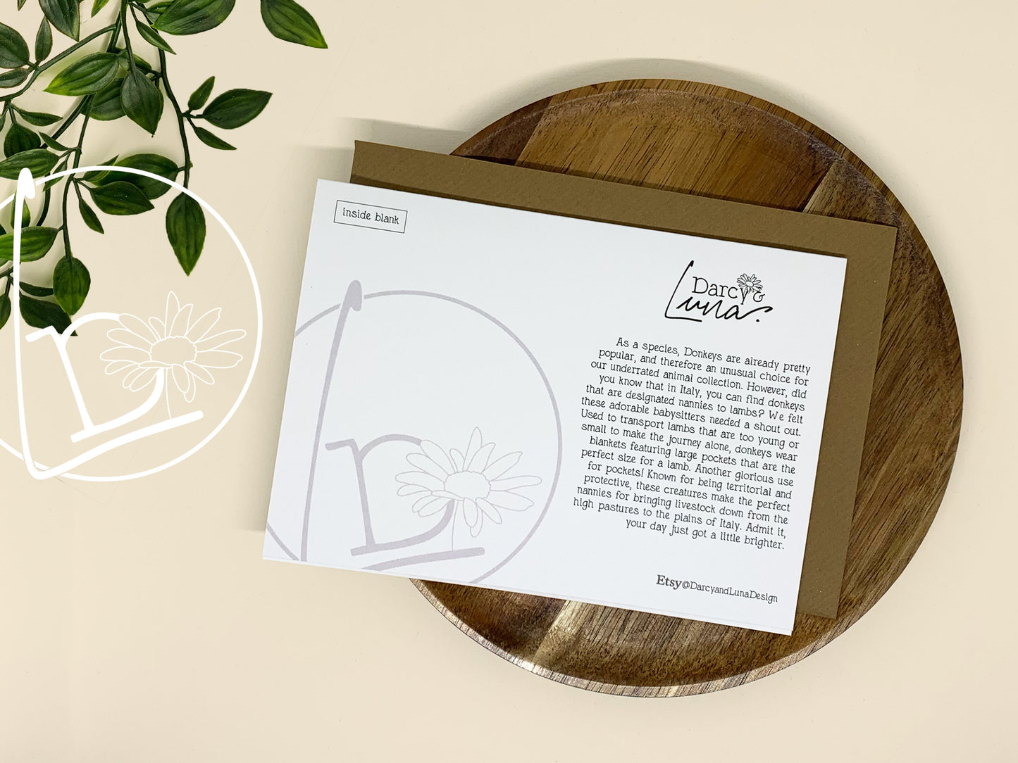 Back of an illustrated card of a donkey carrying 3 lambs the pockets of his coat.