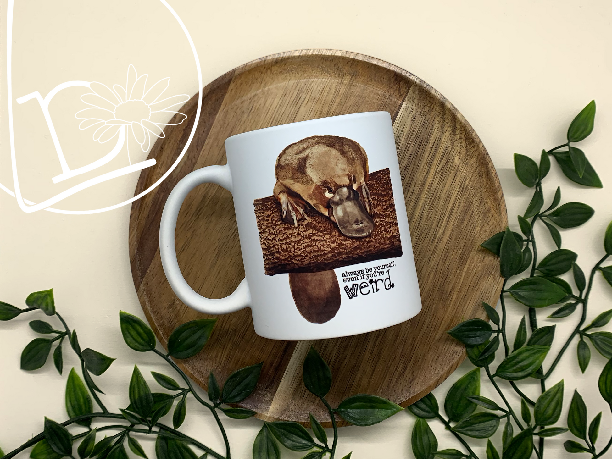 Illustrated platypus mug. The text says "Always be yourself, even if you're weird."