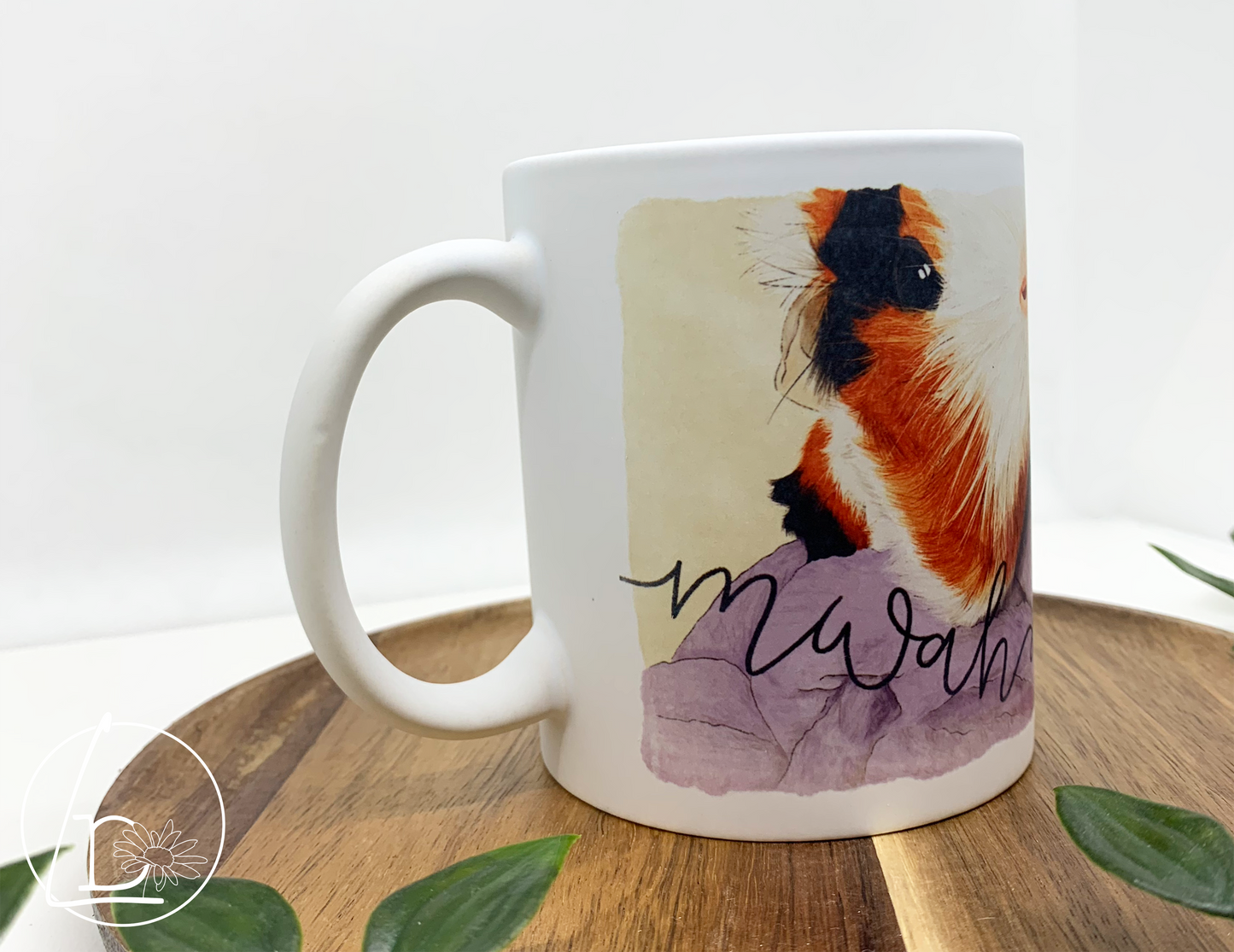 Illustrated mug of a black, white and ginger mug. The text says "mwah"