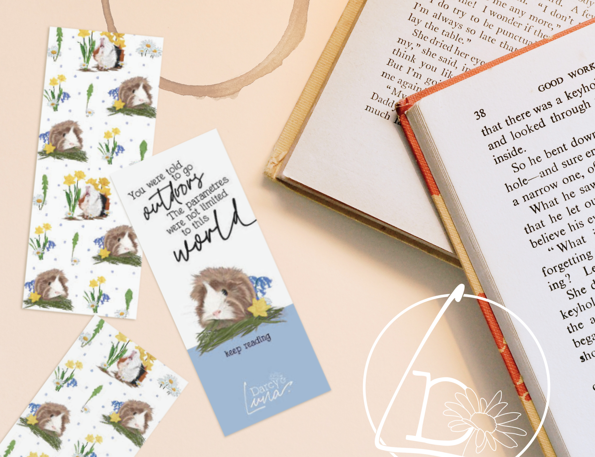 Bookmarks and books on a table. The bookmarks feature guinea pigs, dandelion leaves, flowers the quote "You were told to go outdoors. The parameters were not limited to this world. Keep reading."