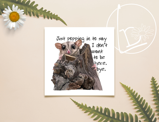 Illustration of a sugar glider popping it's head over the top of a broken tree stump. The slogan says "Just popping in to say I don't want to be here. Bye."