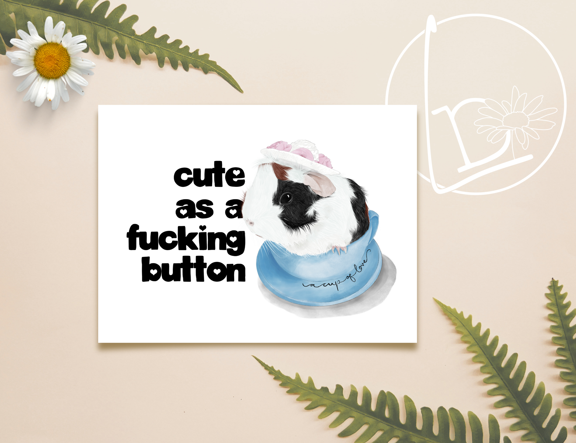 Illustration of a black, white and ginger guinea pig sitting in a blue tea cup and wearing a white sunhat with pink flowers. On the tea cup are the words "a cup of love" and the slogan says "cute as a fucking button."