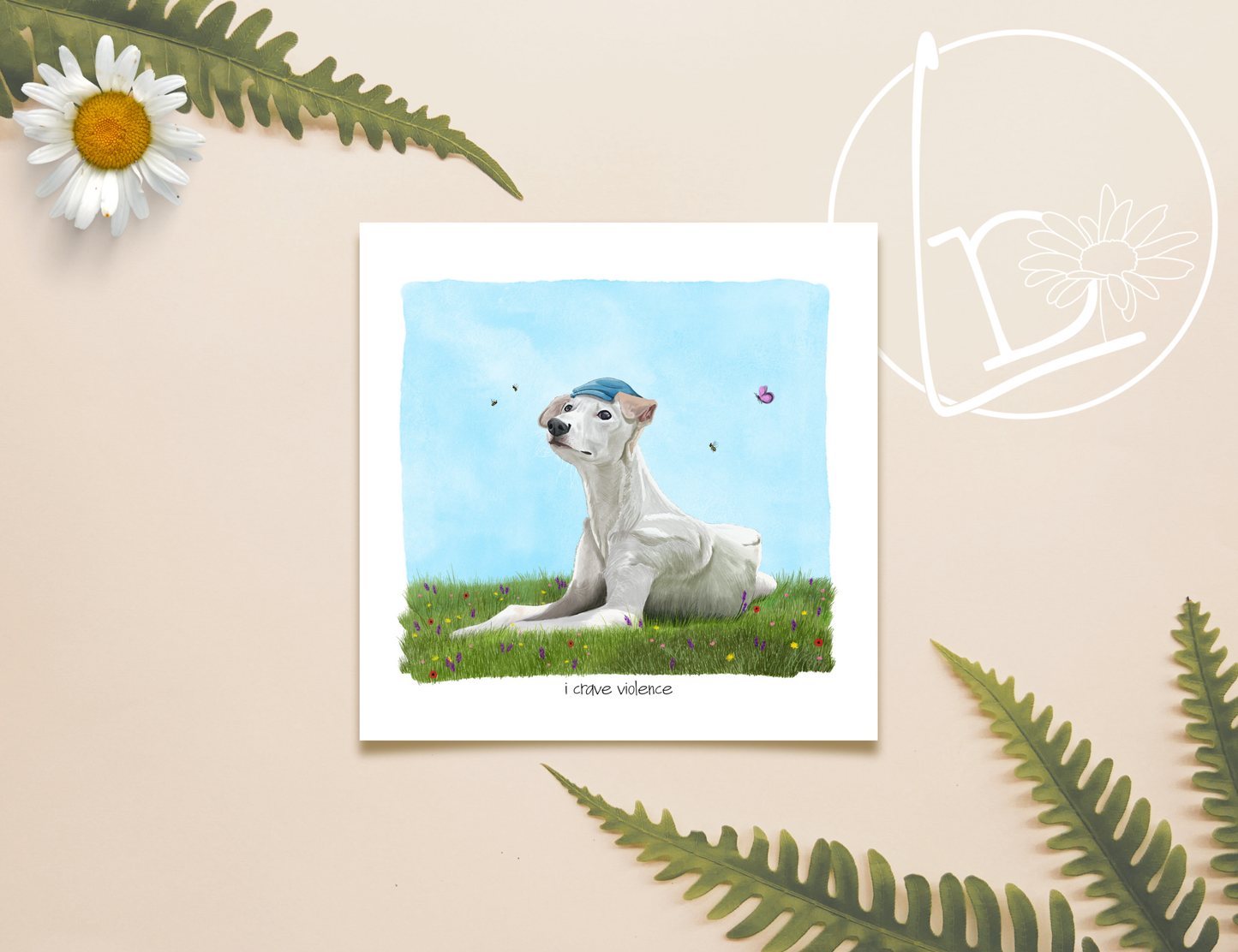 Illustration of a white lurcher with tan ears and wearing a blue flat cap. She sits on grass, surrounded by flowers, bees and butterflies. She looks peaceful and angelic. Underneath are the words " I crave violence."