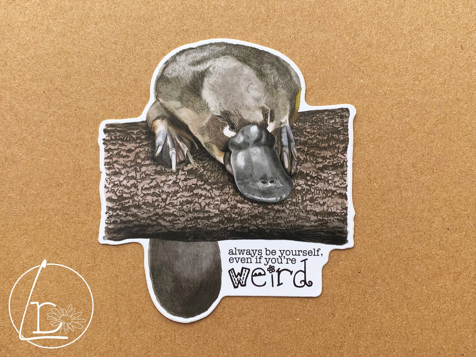 Illustrated platypus sticker. The text says "Always be yourself, even if you're weird."