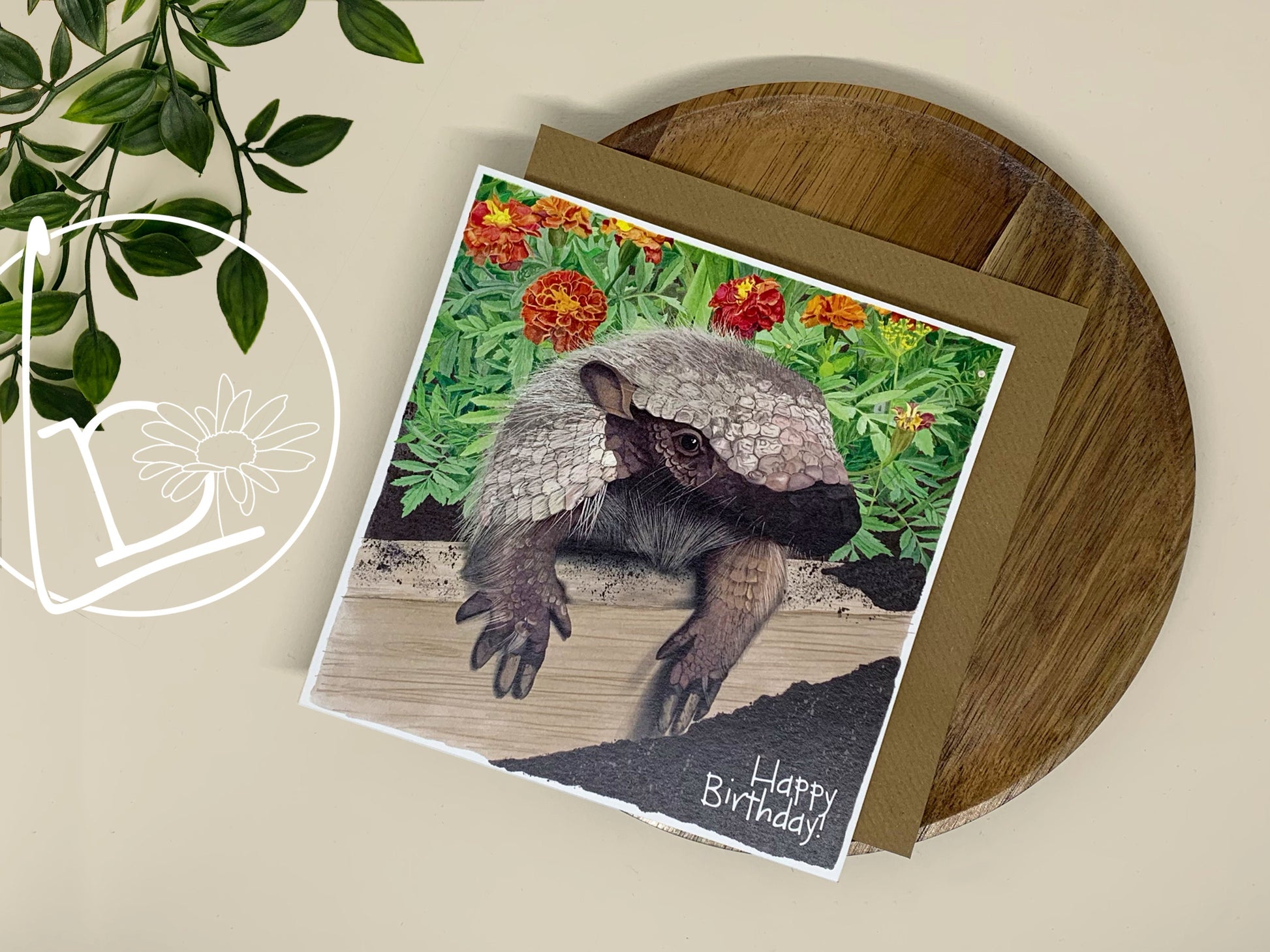 Illustrated greeting card with an armadillo crawling out of a flower bed. The text says "Happy Birthday?"